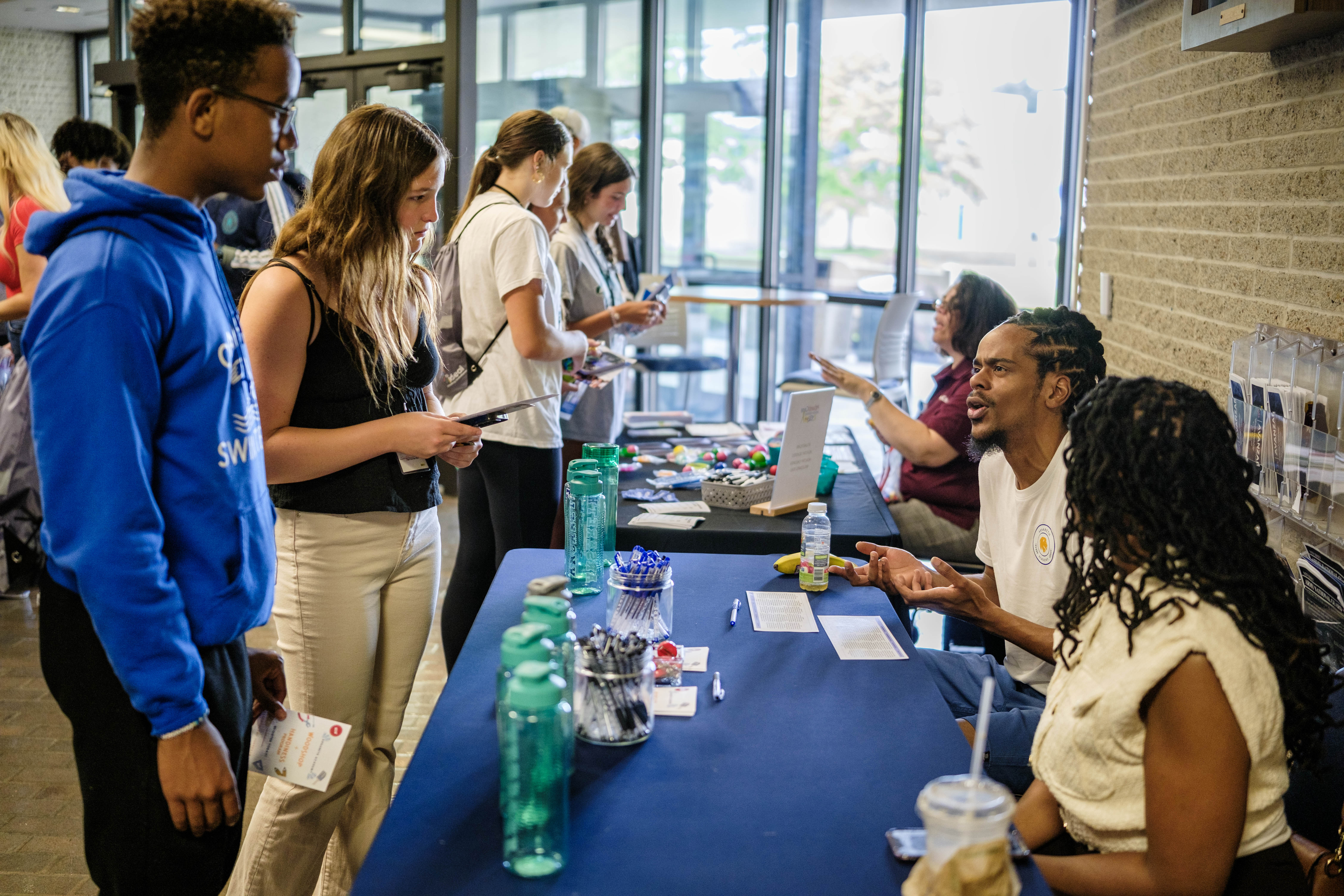 Students speak with some of the vendors at Teen Summit 2024