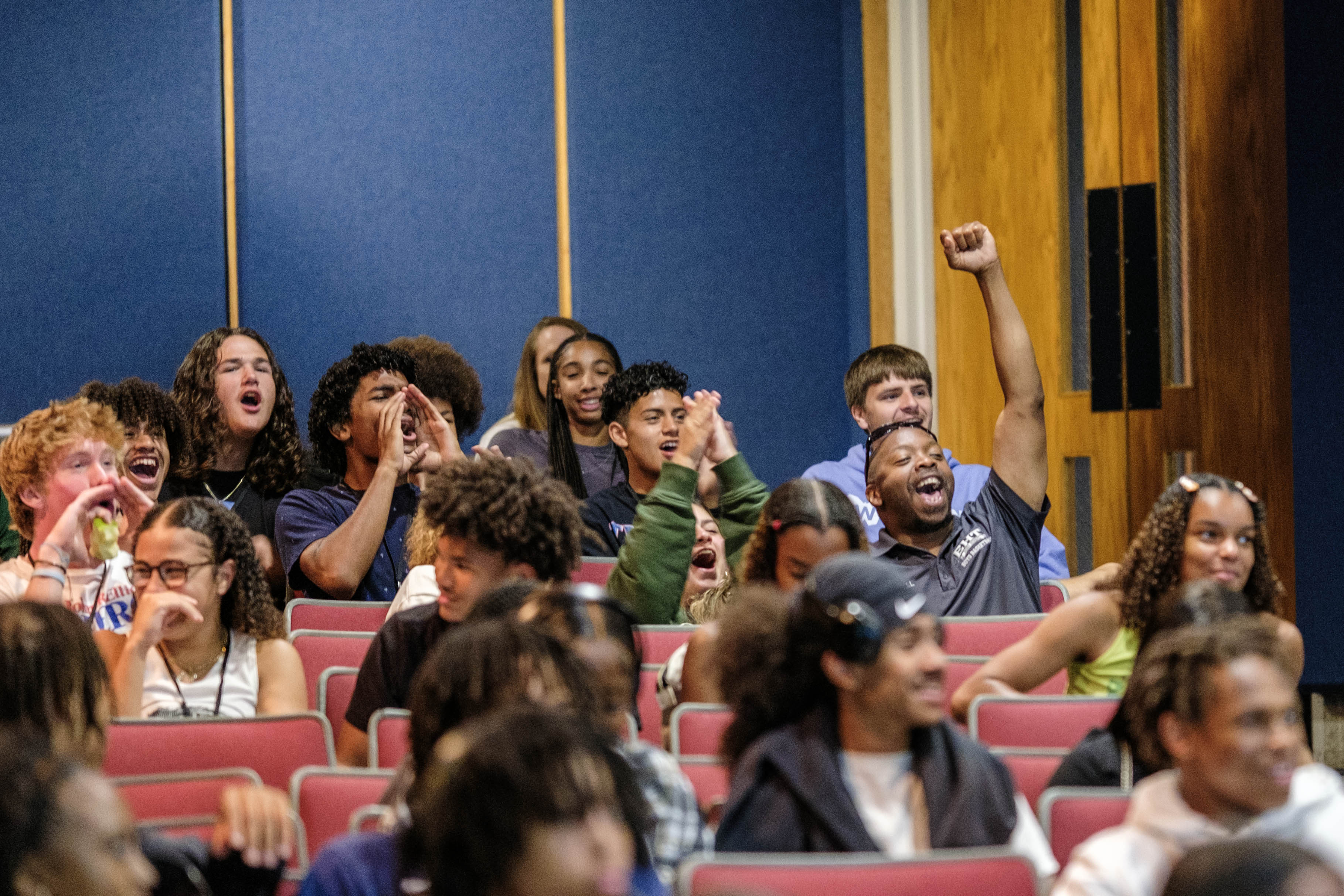 Students cheer as their high school is announced