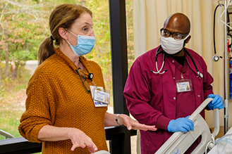 Two nurses standing together in a lab