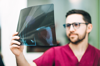 A nurse examines an x-ray sheet