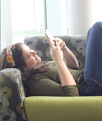 Student lounging and checking her phone