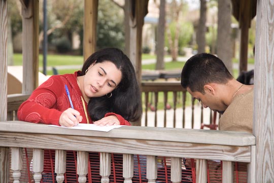 Student writing outside