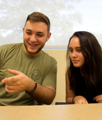 Two students in front of a computer