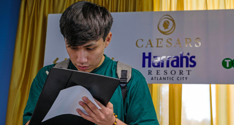 Atlantic Cape student fills out an application during the Annual Career Fair