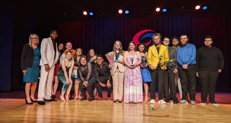 Communication Club students and faculty on stage following the 16th Annual Communication Awards ceremony