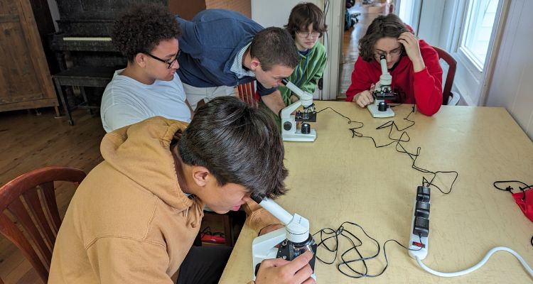 Students from Lower Cape May High School peering through microscopes