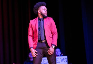 Student in red suit jacket