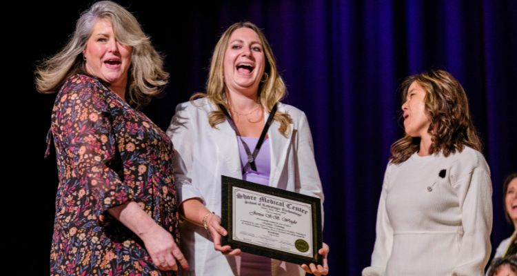 Graduate Jessica White receives her pin and certificate