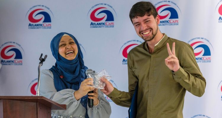 SGA President Sultana Zakia presents an award to Rodrigo Marquez